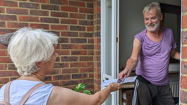 Lib Dem campaigner on the doorstep with a voter