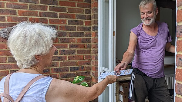 Lib Dem campaigner on the doorstep with a voter